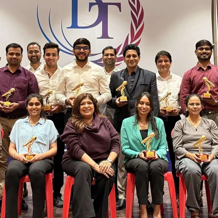 Dynamic Training Institute participants holding their awards