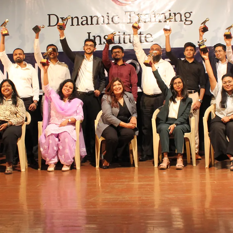 Dynamic Training Institute participants cheering with their trophies