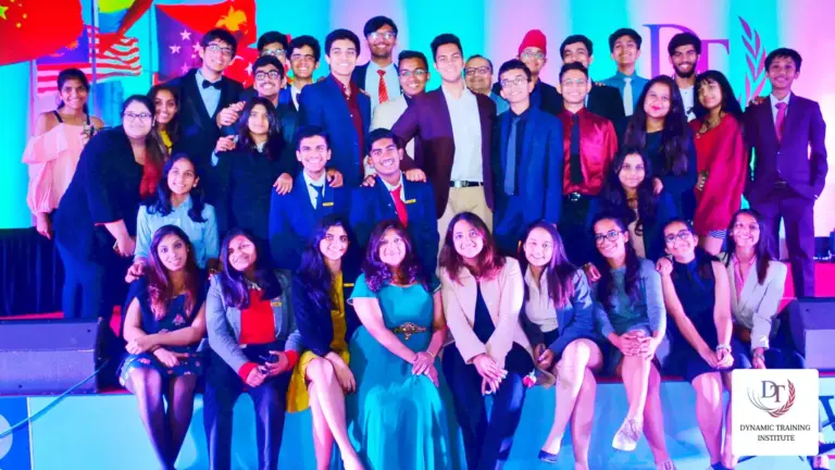 Students in formal clothes at a conference evening, flags behind them