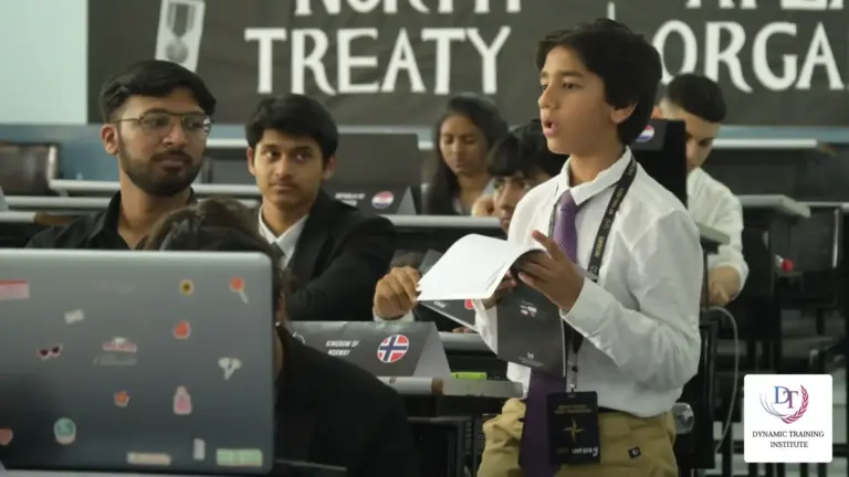 A student delegate speaking from his notes in a committee session, under a North Atlantic Treaty Organization sign