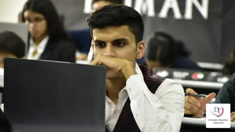 A student delegate listening closely at his laptop during a committee session