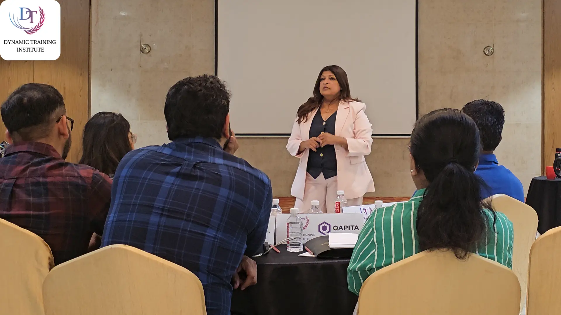 Tina Shah leading a training session for a seated group of professionals