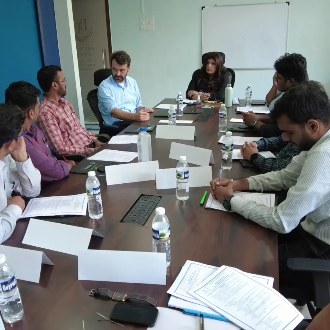 A corporate team in a workshop around a boardroom table