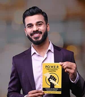 Vikrant, CEO and author, holding his book POWER - The Success Mantra