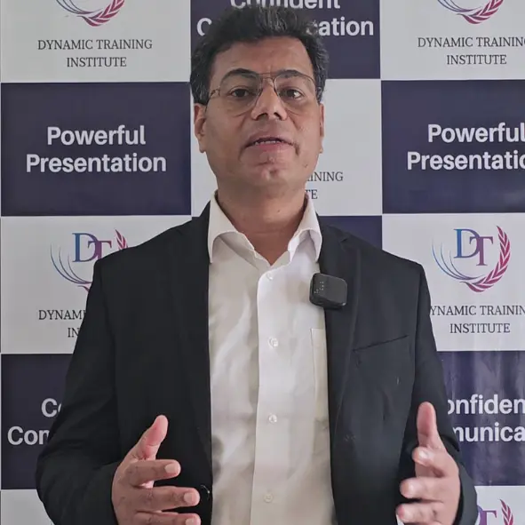 Anmol, Managing Director, speaking in front of a Dynamic Training Institute backdrop