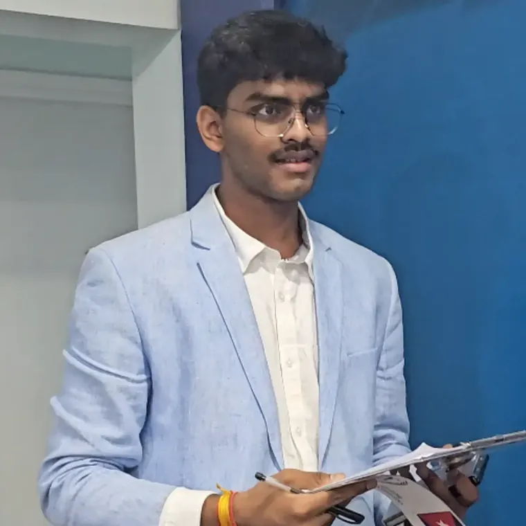 A student in a light blue blazer speaking from his notes