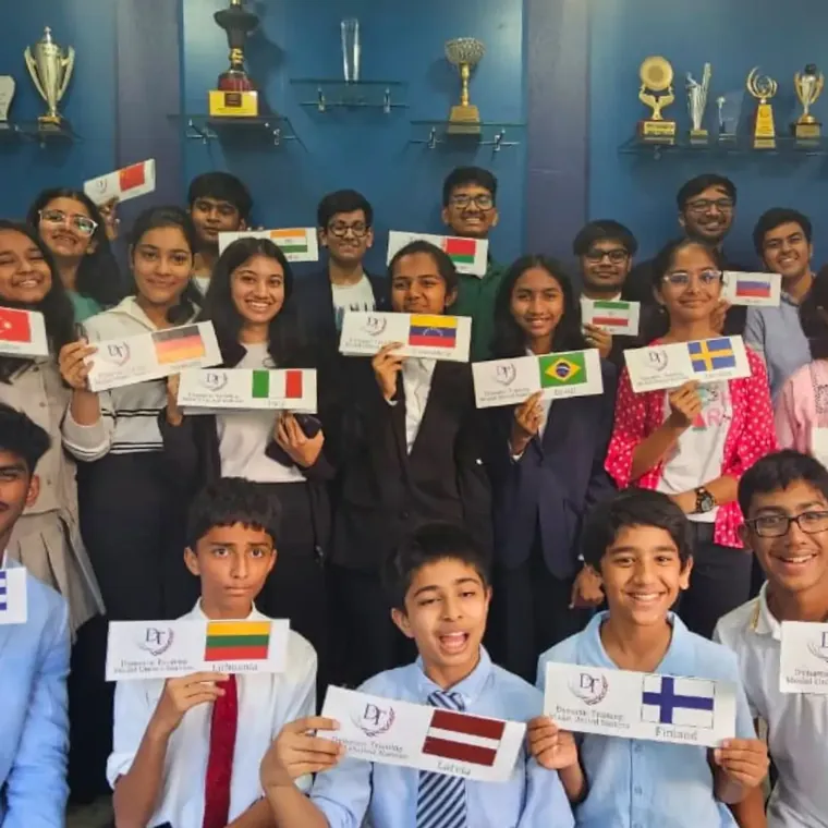 Students holding country name cards with flags, ready for a Model United Nations session