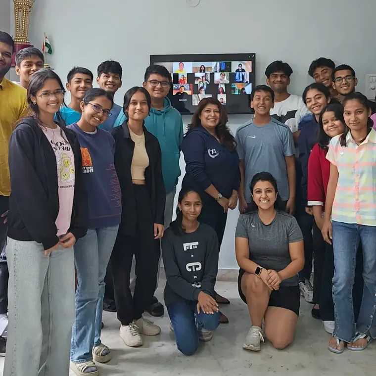 A large group of students posing together in a classroom