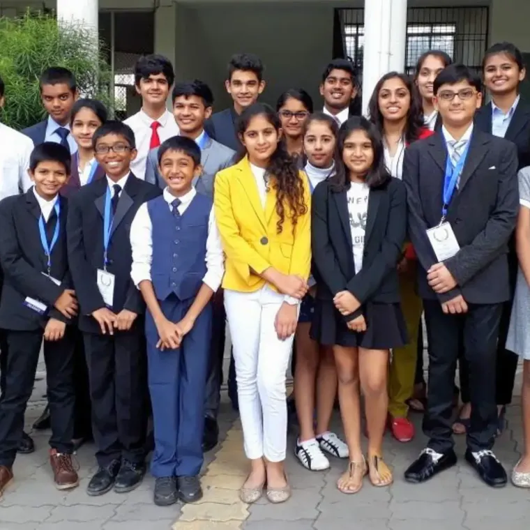 Students in school blazers and formal clothes posing as a group