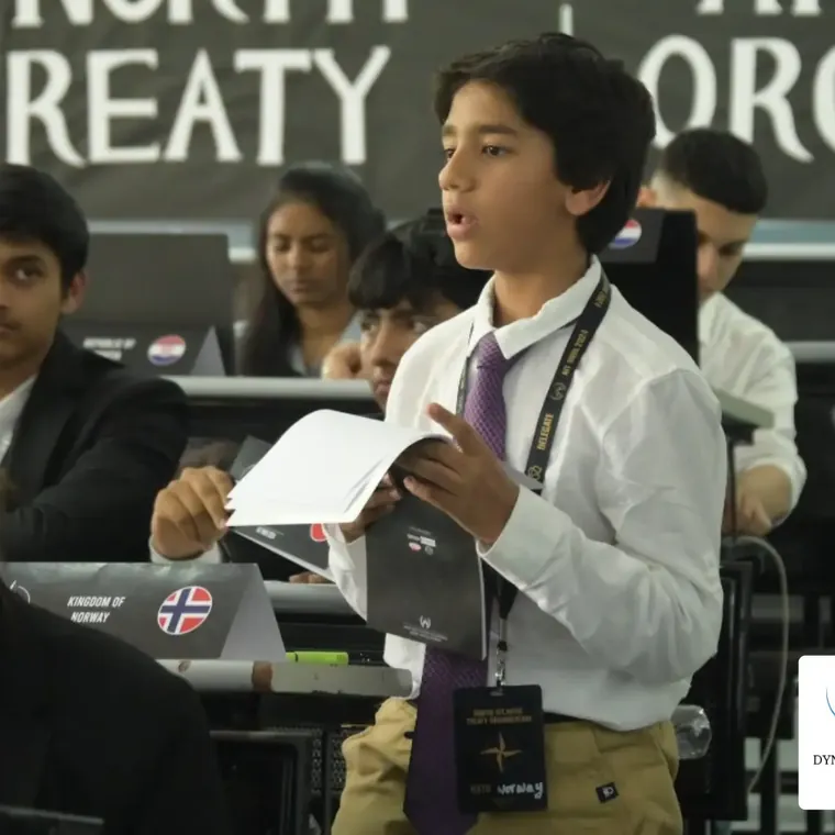 A student delegate speaking from his notes in a committee session