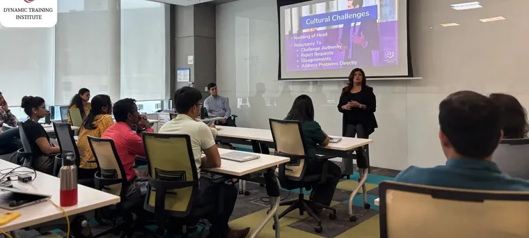 Tina Shah teaching a corporate workshop on cultural challenges, participants seated at desks
