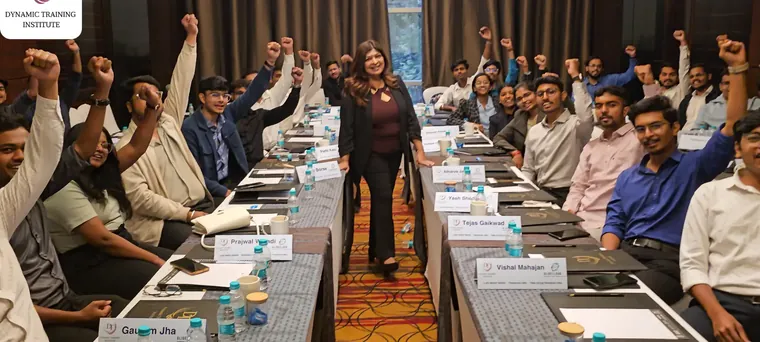 Tina Shah standing among cheering participants at a training session