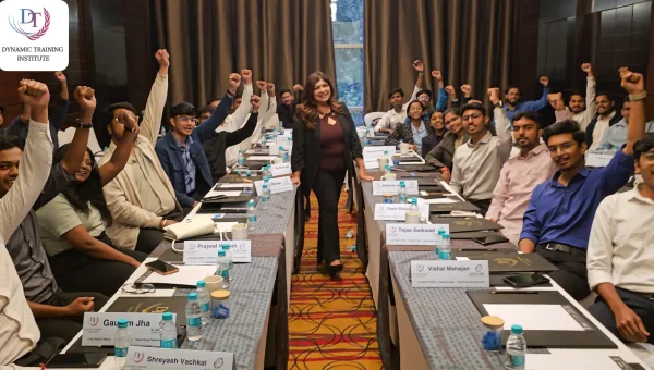 Tina Shah standing among cheering participants at a training session