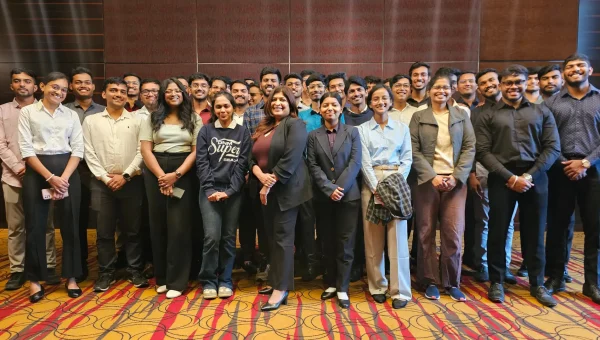 Group photo of a large corporate training batch standing together in a hotel hall
