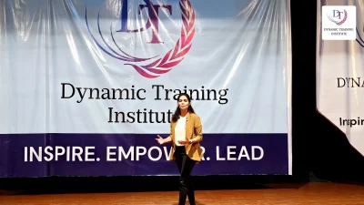 A participant speaking on stage at Dynamic Training Institute